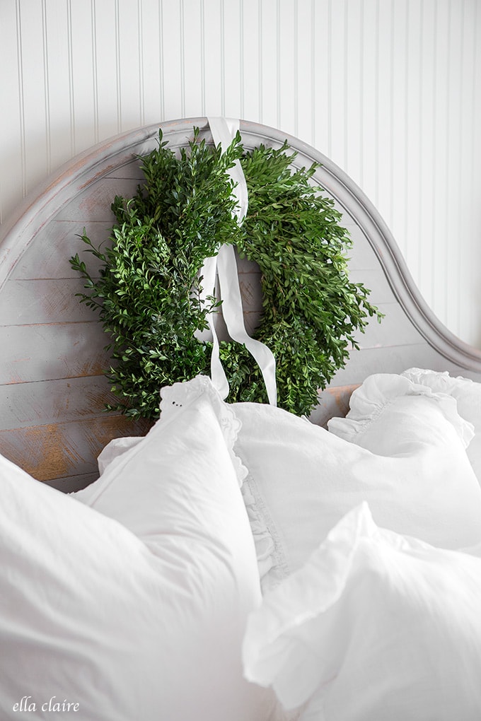 Fresh boxwood wreaths in a Christmas bedroom