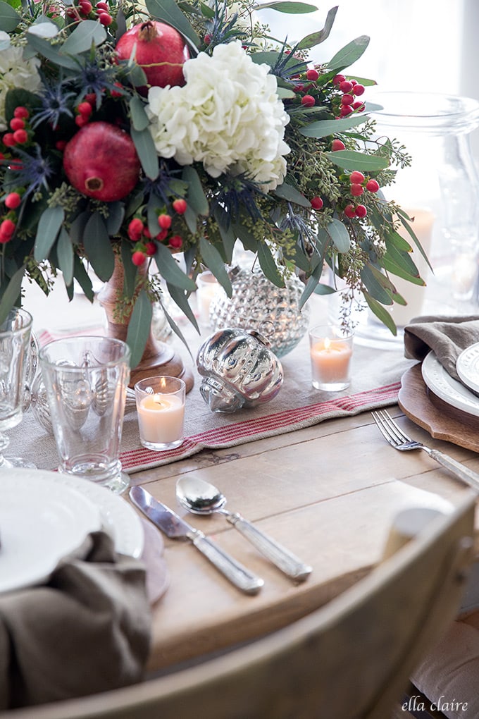A simple and beautiful Christmas tablescape with classic traditional red, green gingerbread, pomegranates and berries in the warm glow of candlelight. 
