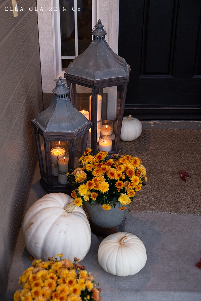 mums and lanterns aglow on a cozy fall porch 