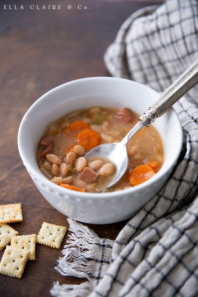 Easy and delicious slow cooker white bean and ham soup recipe takes only 10 minutes to throw together and the crockpot does all of the work! Serve with crusty bread or crackers and you have the perfect Fall or Winter Dinner. 