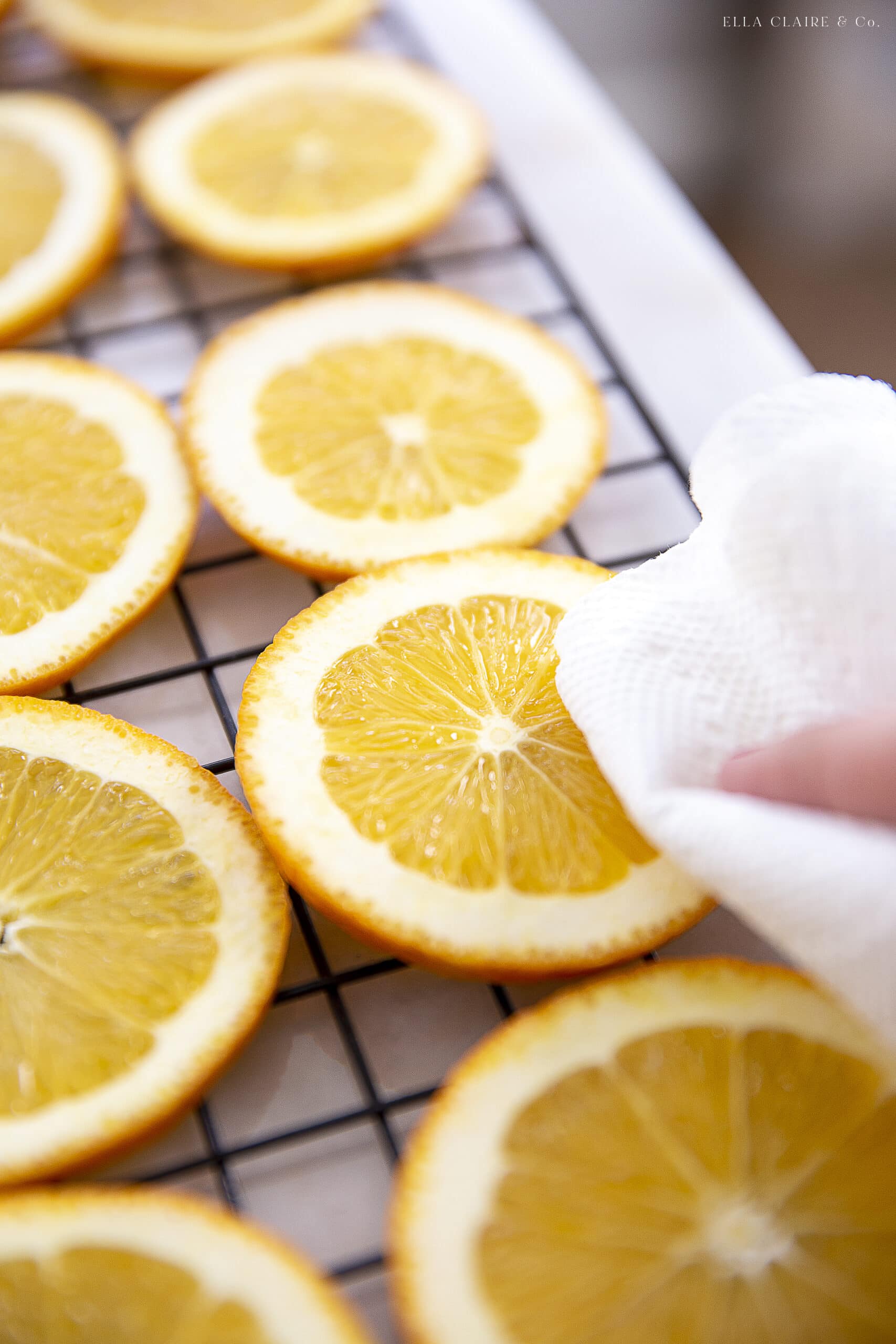 patting dry orange slices before dehydrating