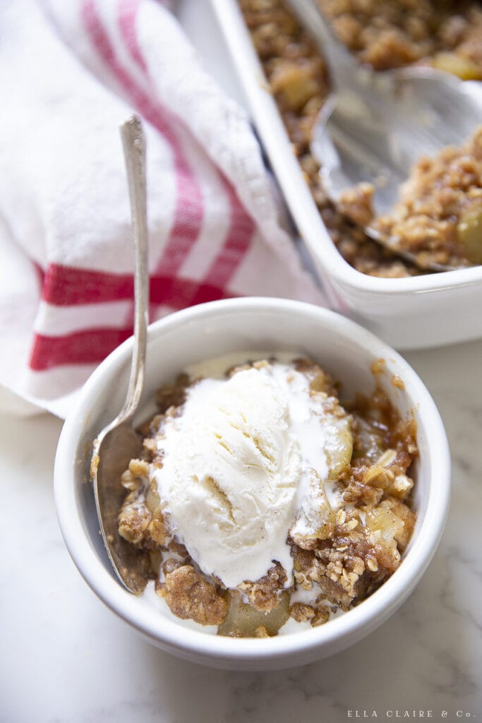 vanilla ice cream on top of apple crisp with oats