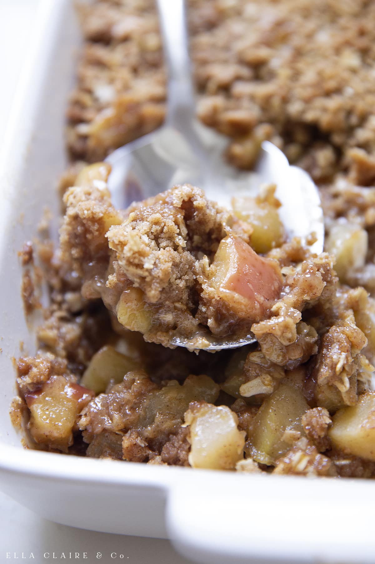 scooping out the apple crumble with oat topping