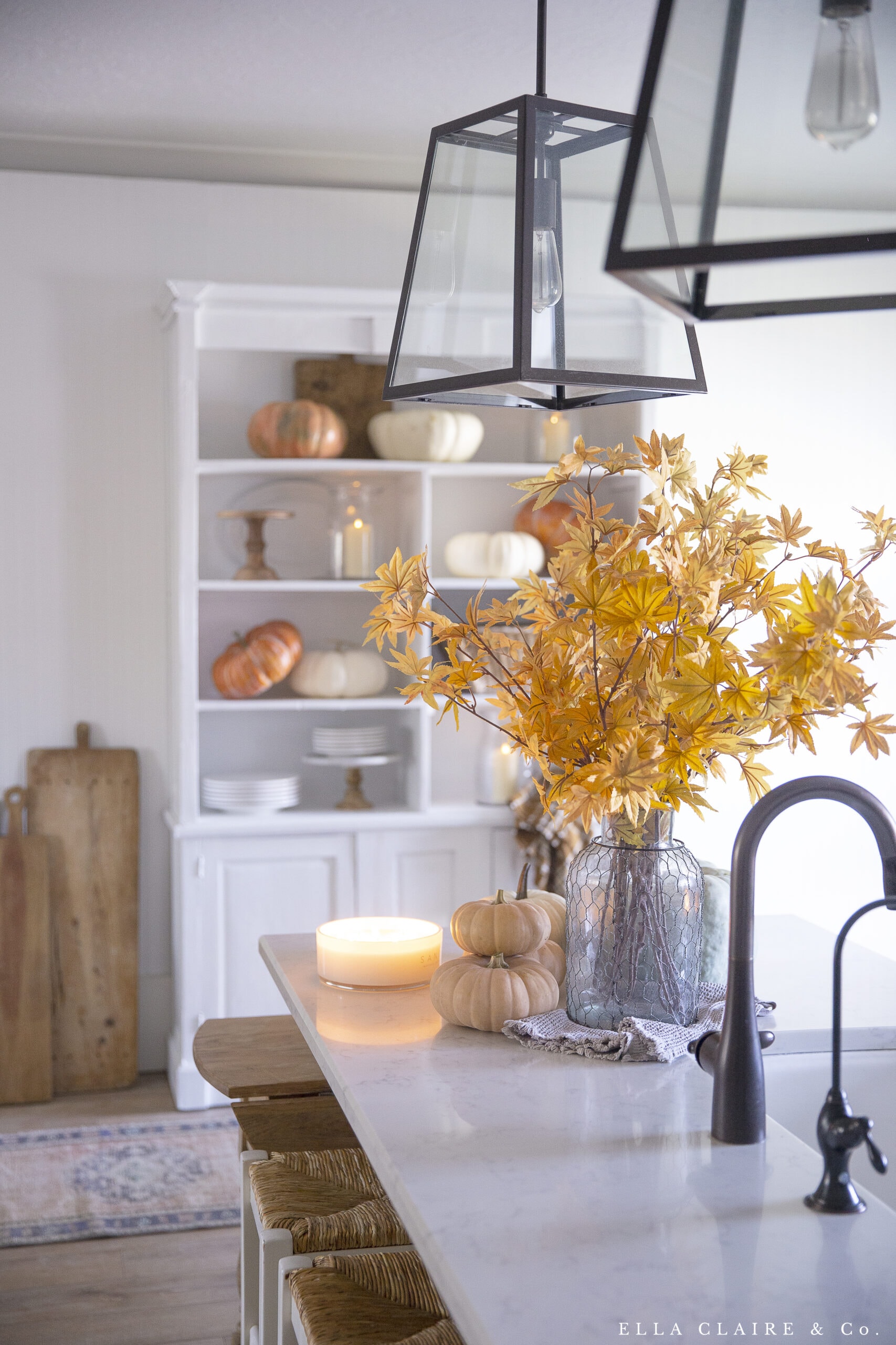 fall leaves and pumpkins with vintage bread boards in kitchen