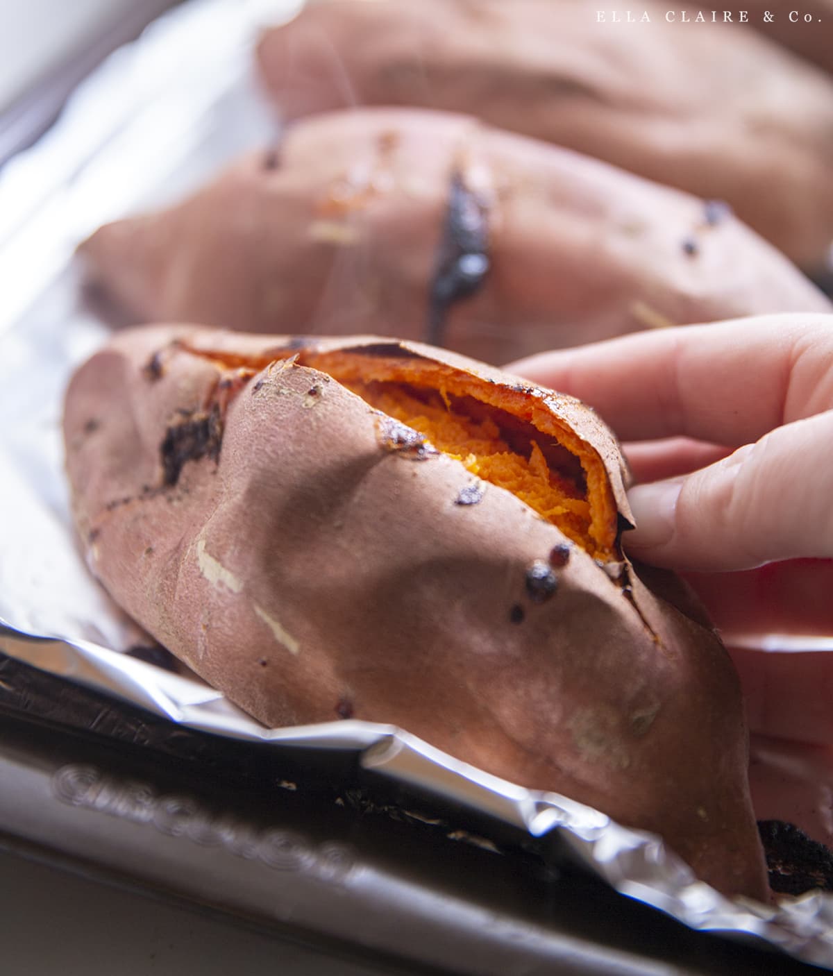 cutting open sweet potato with steam
