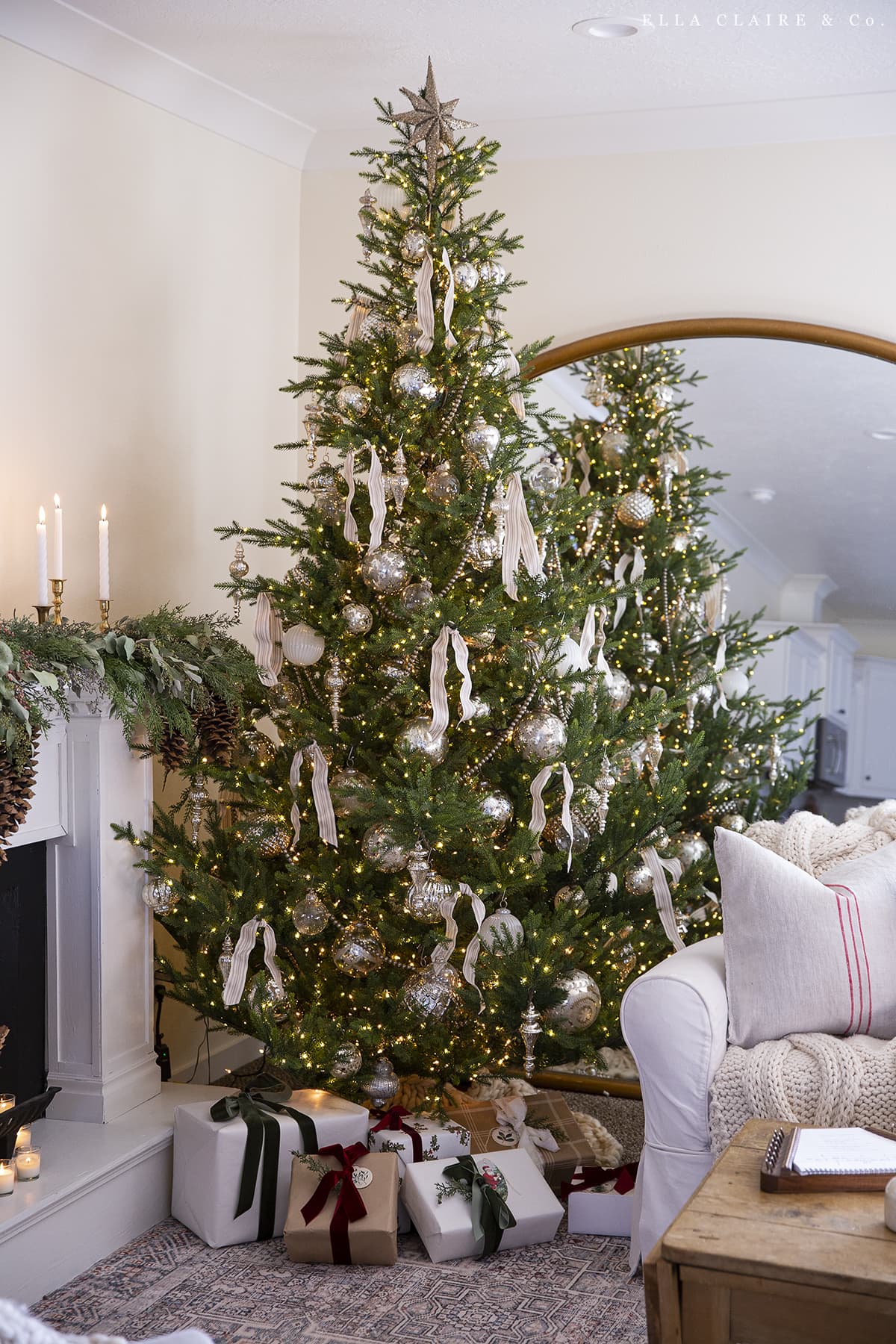 green Christmas tree with elegant cream ribbon and mercury glass ornaments