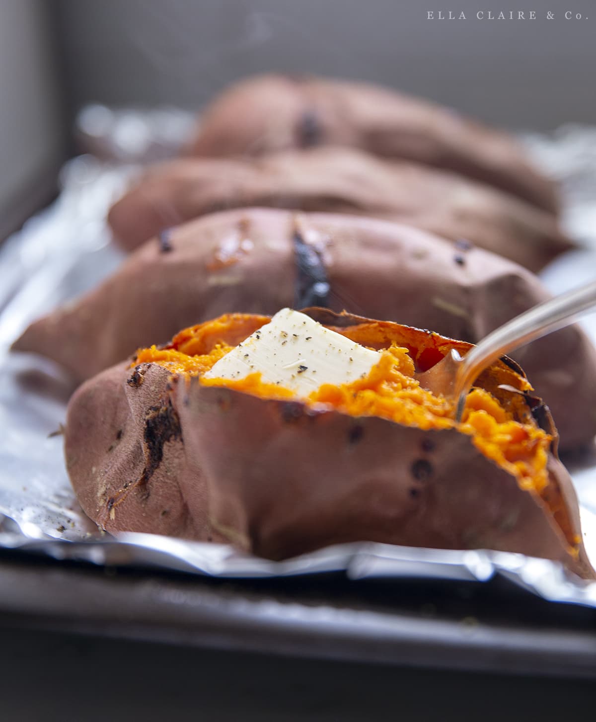 scooping out baked sweet potato with a fork