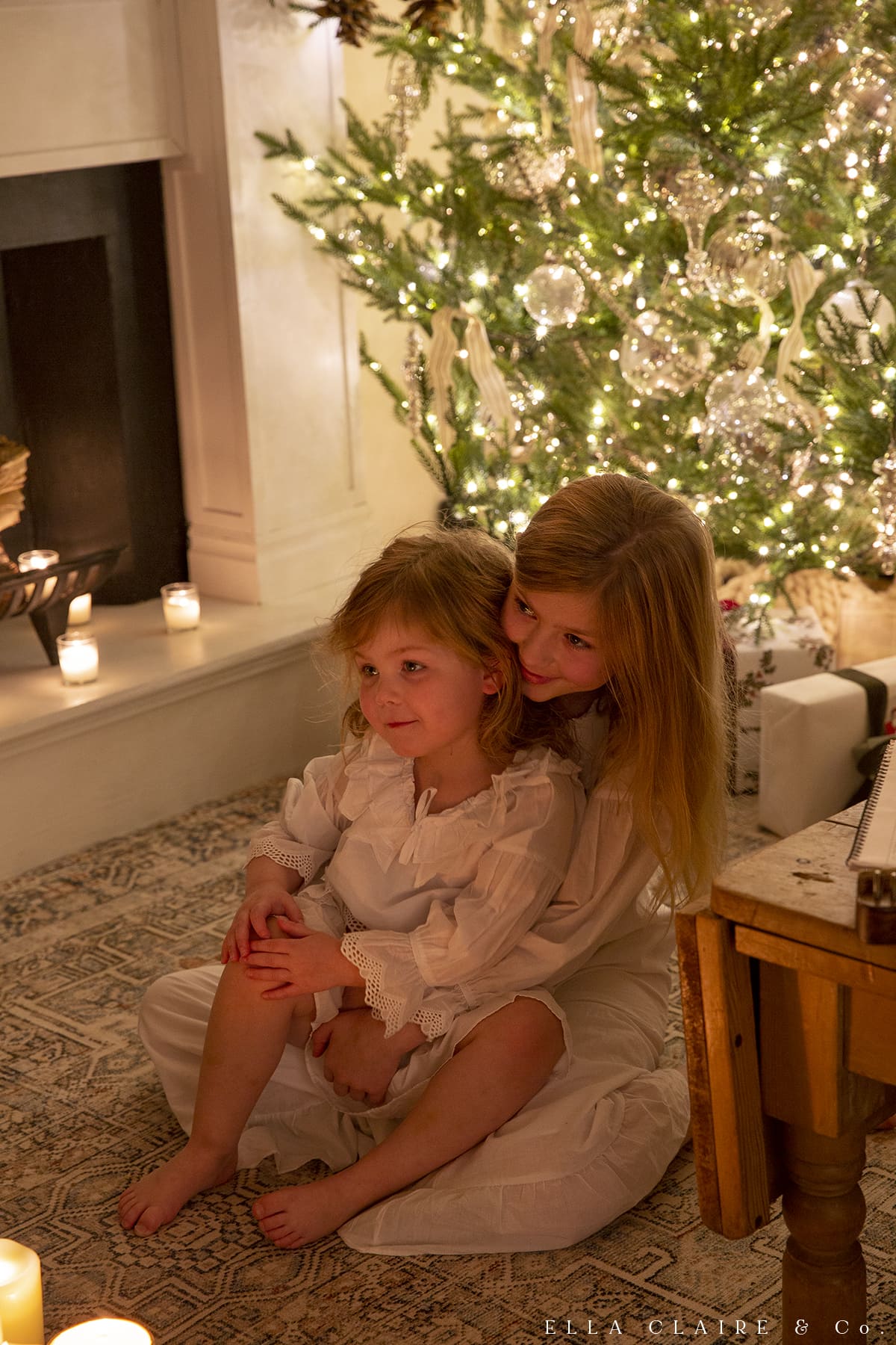 children under the warm glow of a Christmas tree