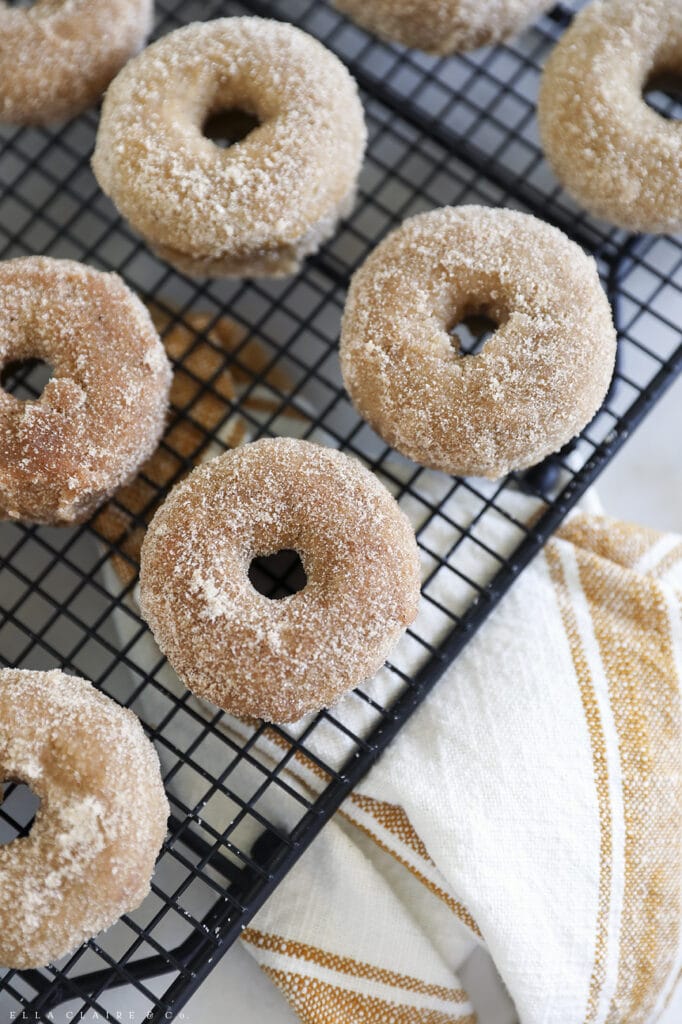 homemade baked cinnamon sugar doughnuts on a baking rack