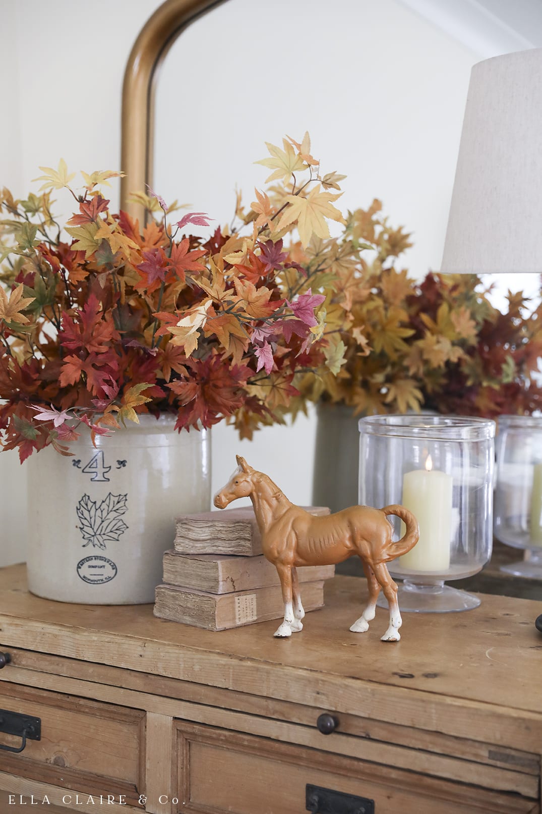 colorful warm fall leaves and cast iron horse piggy bank